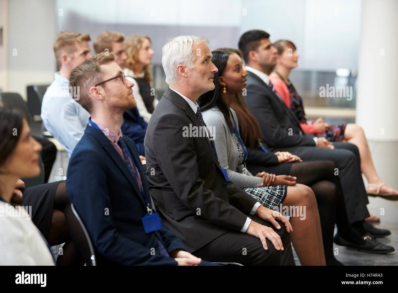 Audience Listening To  Speaker At Conference Presentation Stock Photo