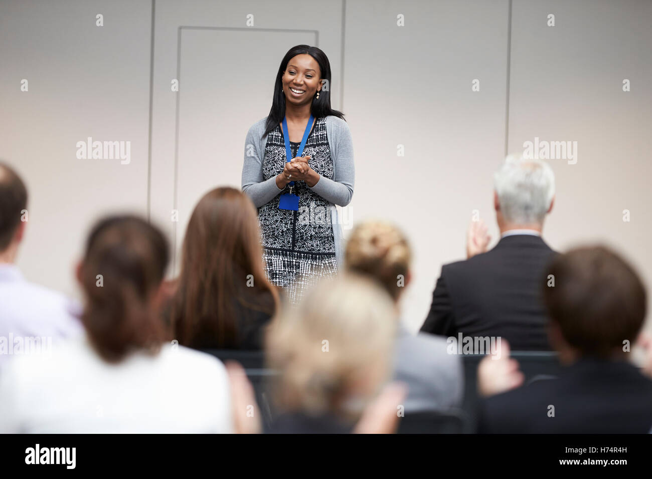 Audience Applauding Speaker After Conference Presentation Stock Photo