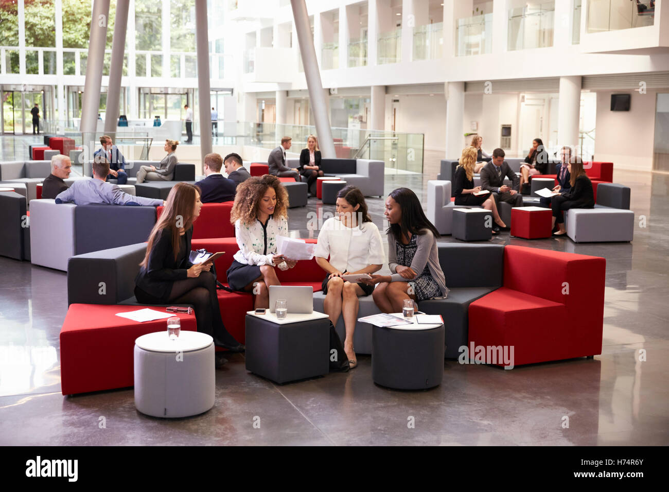 Businesswomen Meeting In Busy Lobby Of Modern Office Stock Photo - Alamy