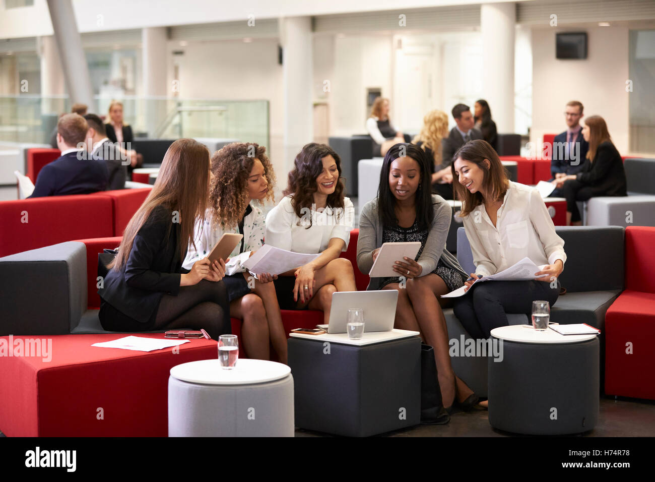 Businesswomen Meeting In Busy Lobby Of Modern Office Stock Photo - Alamy