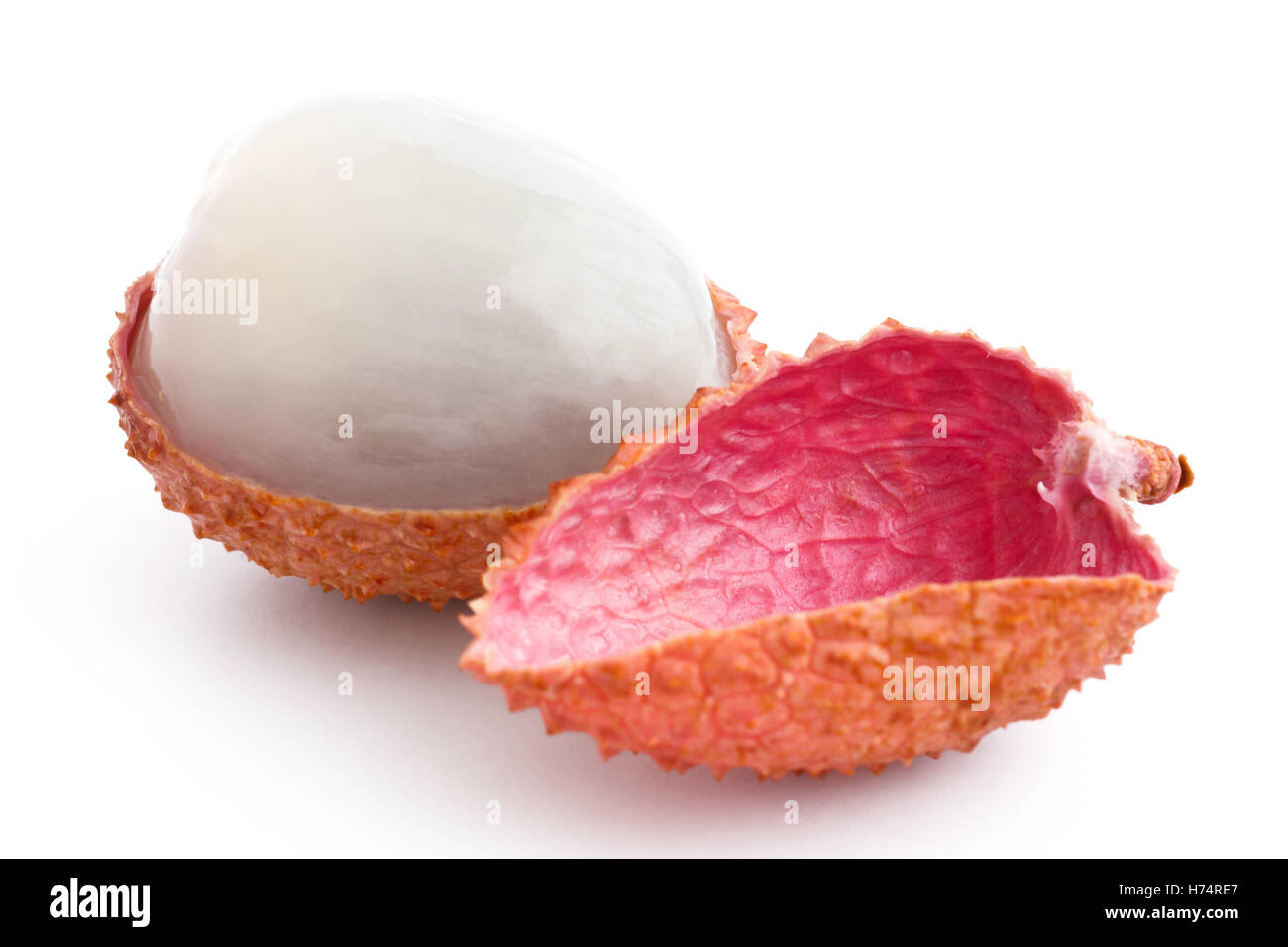 Single litchi with skin removed and flesh. On white. Stock Photo
