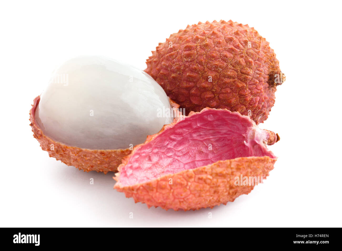 Single litchi with skin removed and flesh. On white. Stock Photo