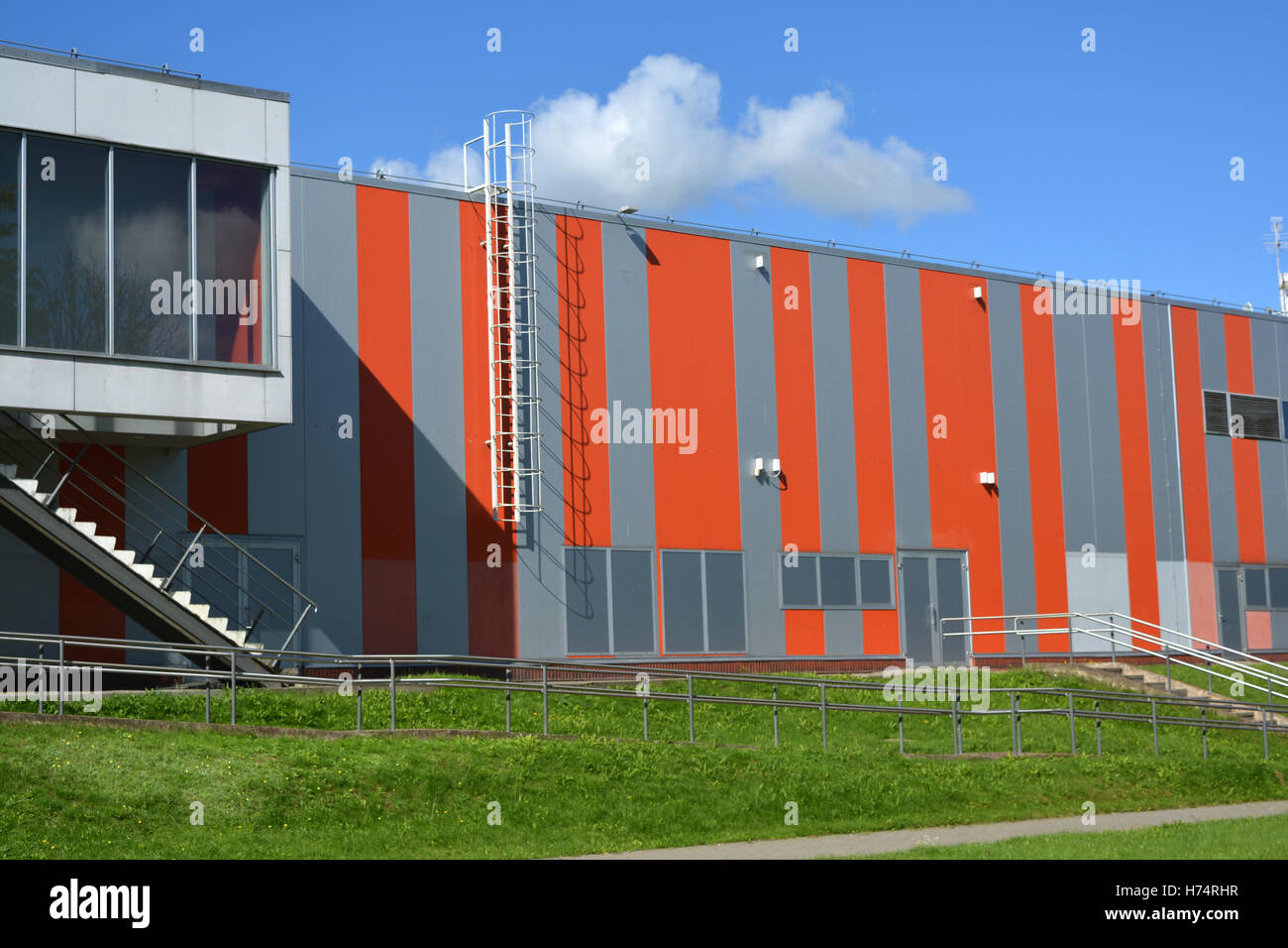modern industrial building wall with metal ladder, stairs and sky ...