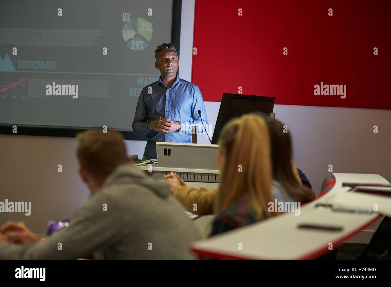 Lecture in a darkened university lecture theatre, student POV Stock Photo
