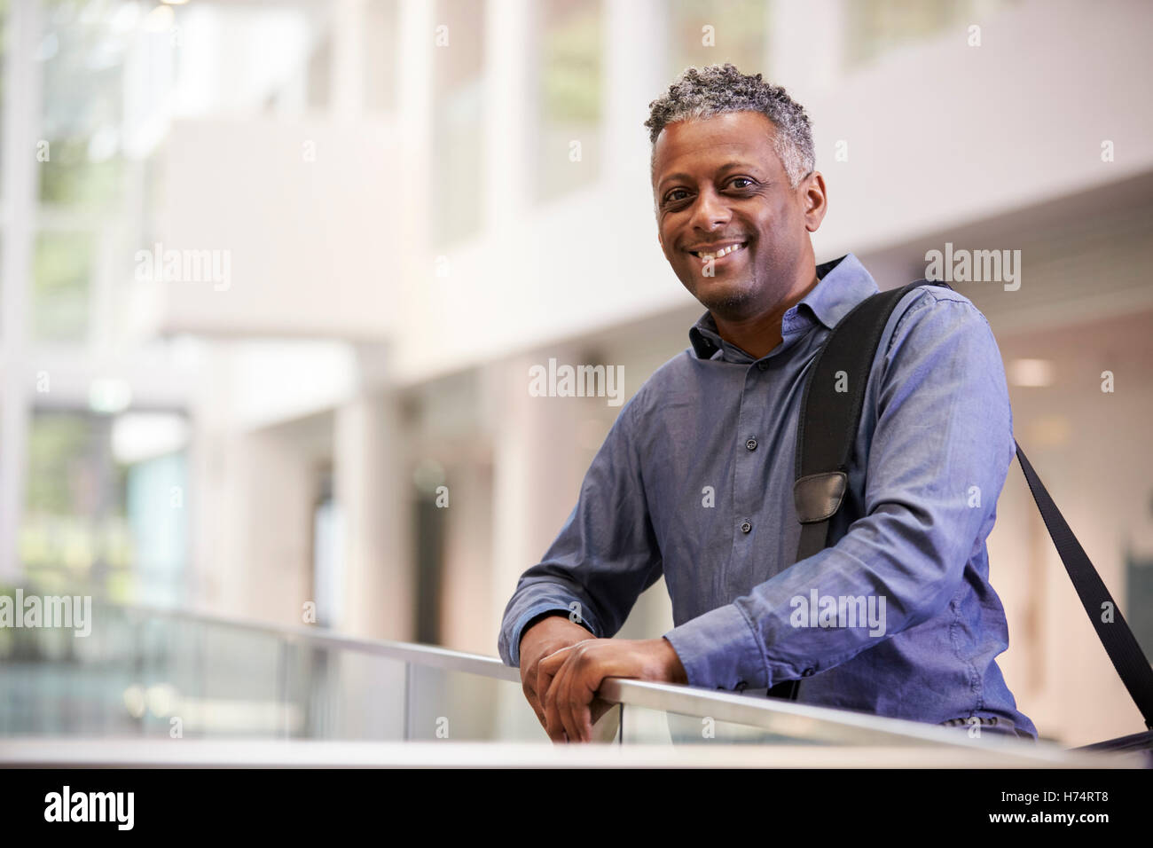 Middle aged black man  smiling in modern building lobby Stock Photo
