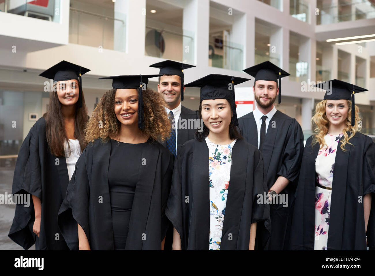 Group portrait of university graduates in cap and gown Stock Photo