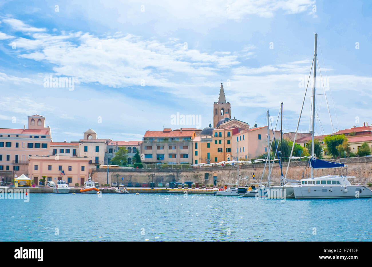 the yachts in the old haven of Alghero with the historic town centre on