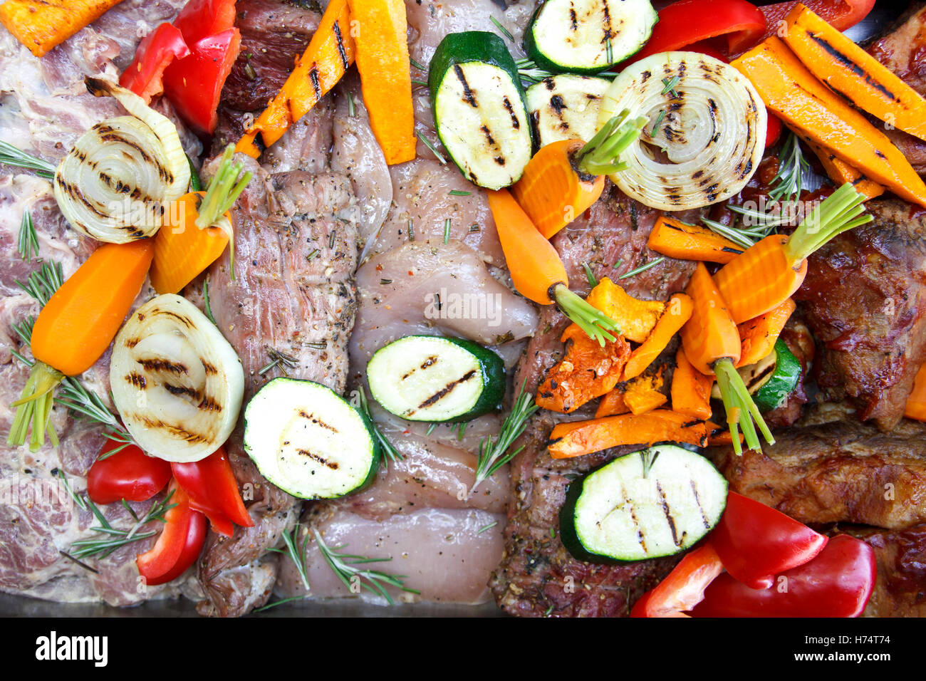 Mixed raw meat and grilled vegetables marinating ready for barbeque. Stock Photo