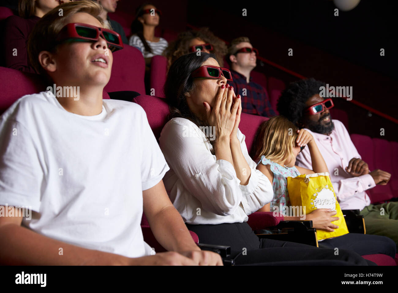 Audience In Cinema Wearing 3D Glasses Watching Horror Film Stock Photo