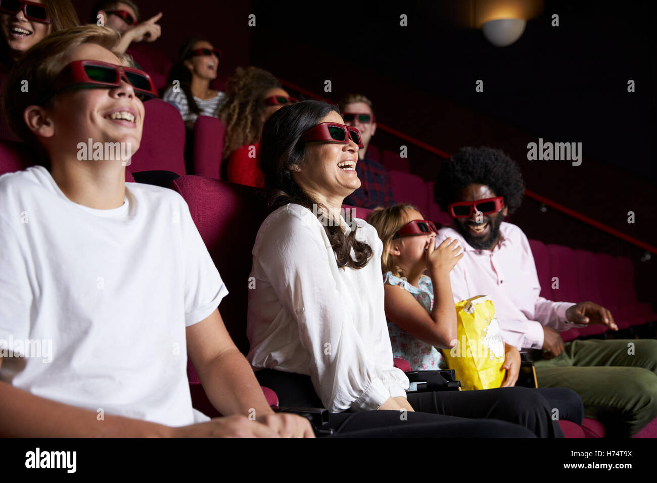 Audience In Cinema Wearing 3D Glasses Watching Comedy Film Stock Photo