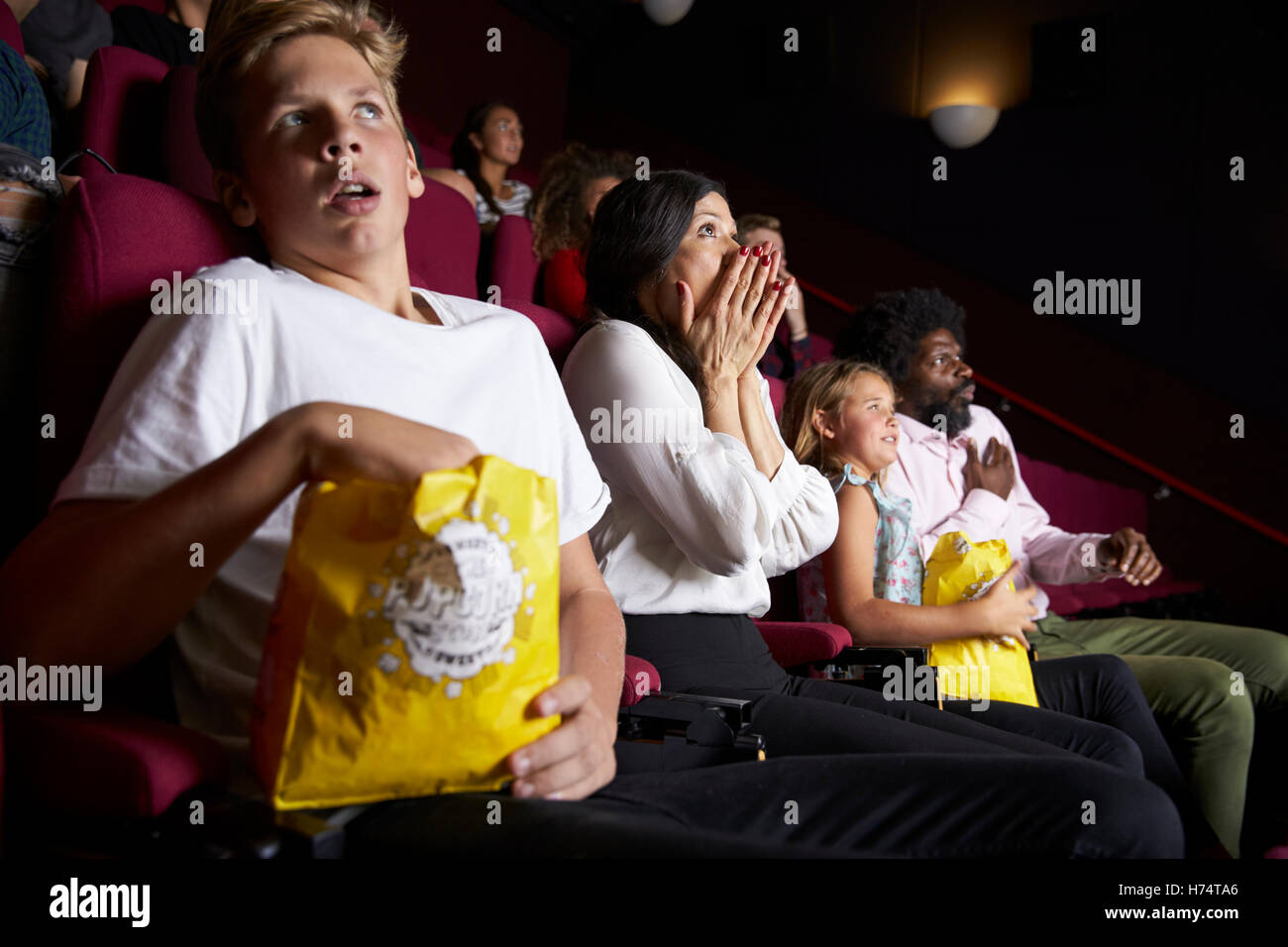 Audience In Cinema Watching Horror Film Stock Photo