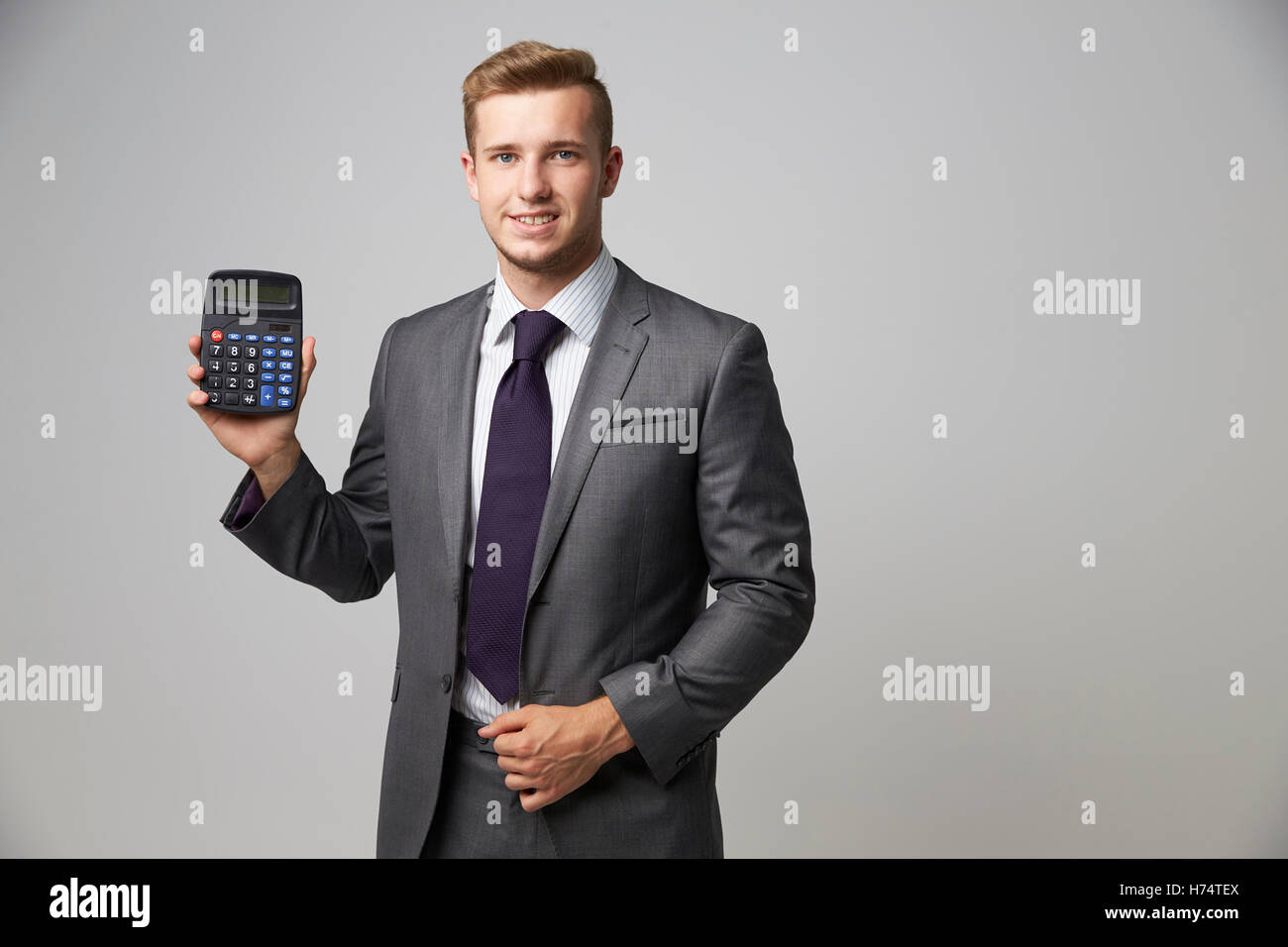 Studio Portrait Of Accountant Using Calculator Stock Photo
