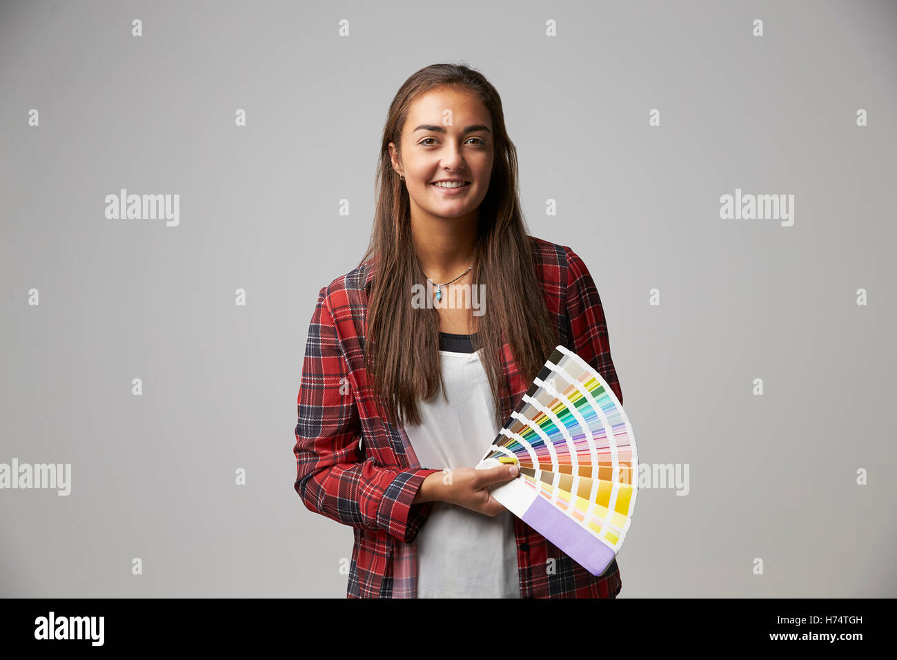 Studio Shot Of Female Graphic Designer With Color Swatches Stock Photo