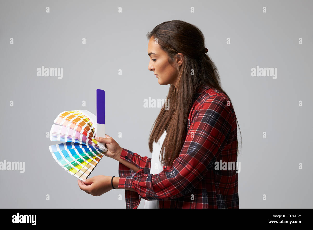 Studio Shot Of Female Graphic Designer With Color Swatches Stock Photo