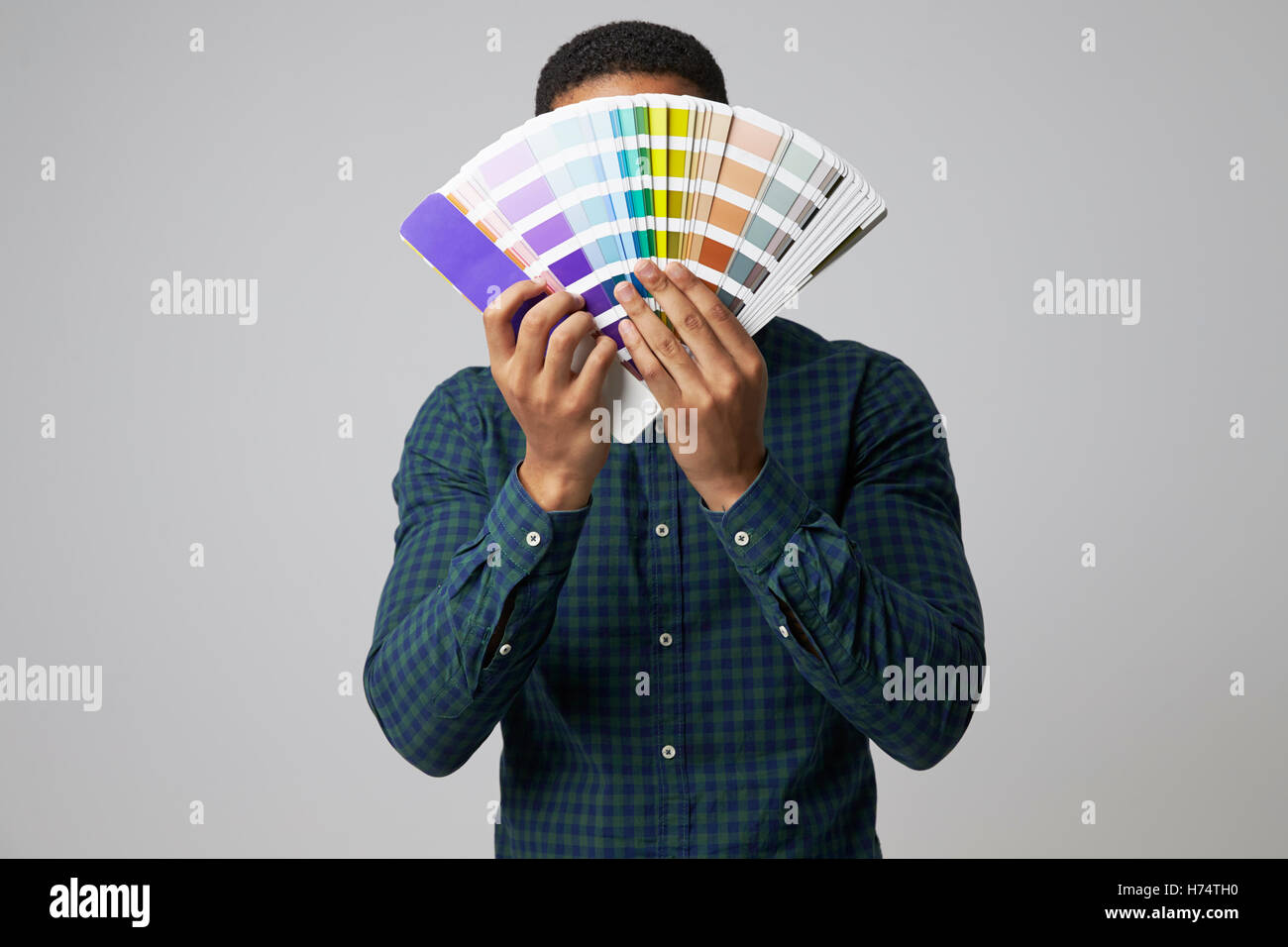 Studio Portrait Of Graphic Designer With Color Swatches Stock Photo