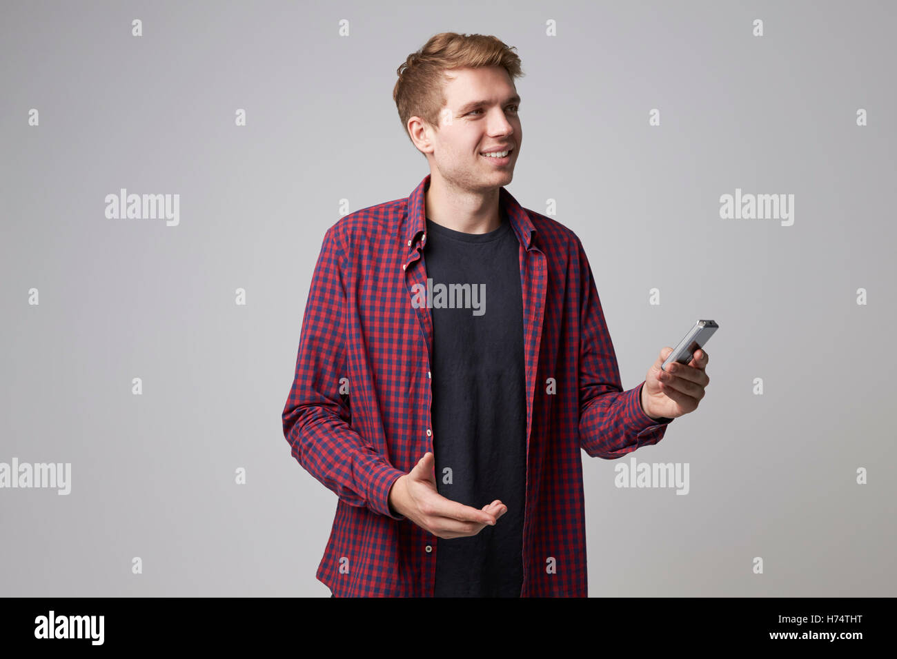 Studio Portrait Of Male Journalist With Digital Recorder Stock Photo