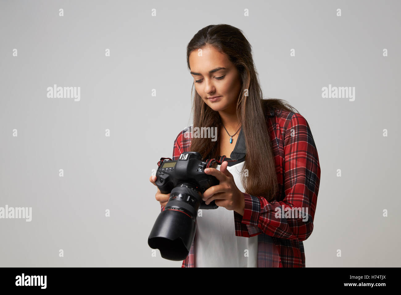 Studio Portrait Of Female Photographer With Camera Stock Photo - Alamy