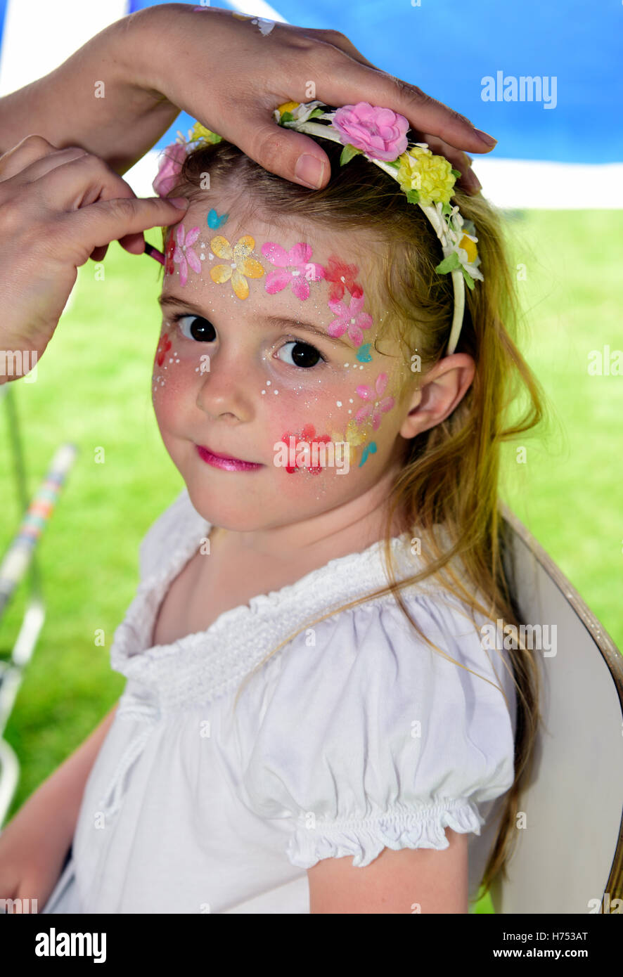 5 year old girl having her face painted at a local village fete, Four Marks, near Alton, Hampshire, UK. Stock Photo