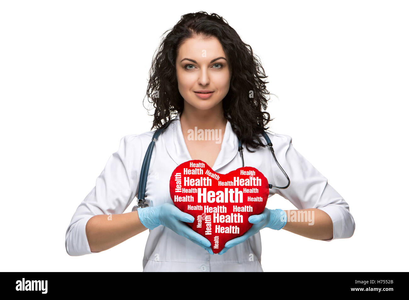 Pretty woman doctor holding a red heart Stock Photo - Alamy