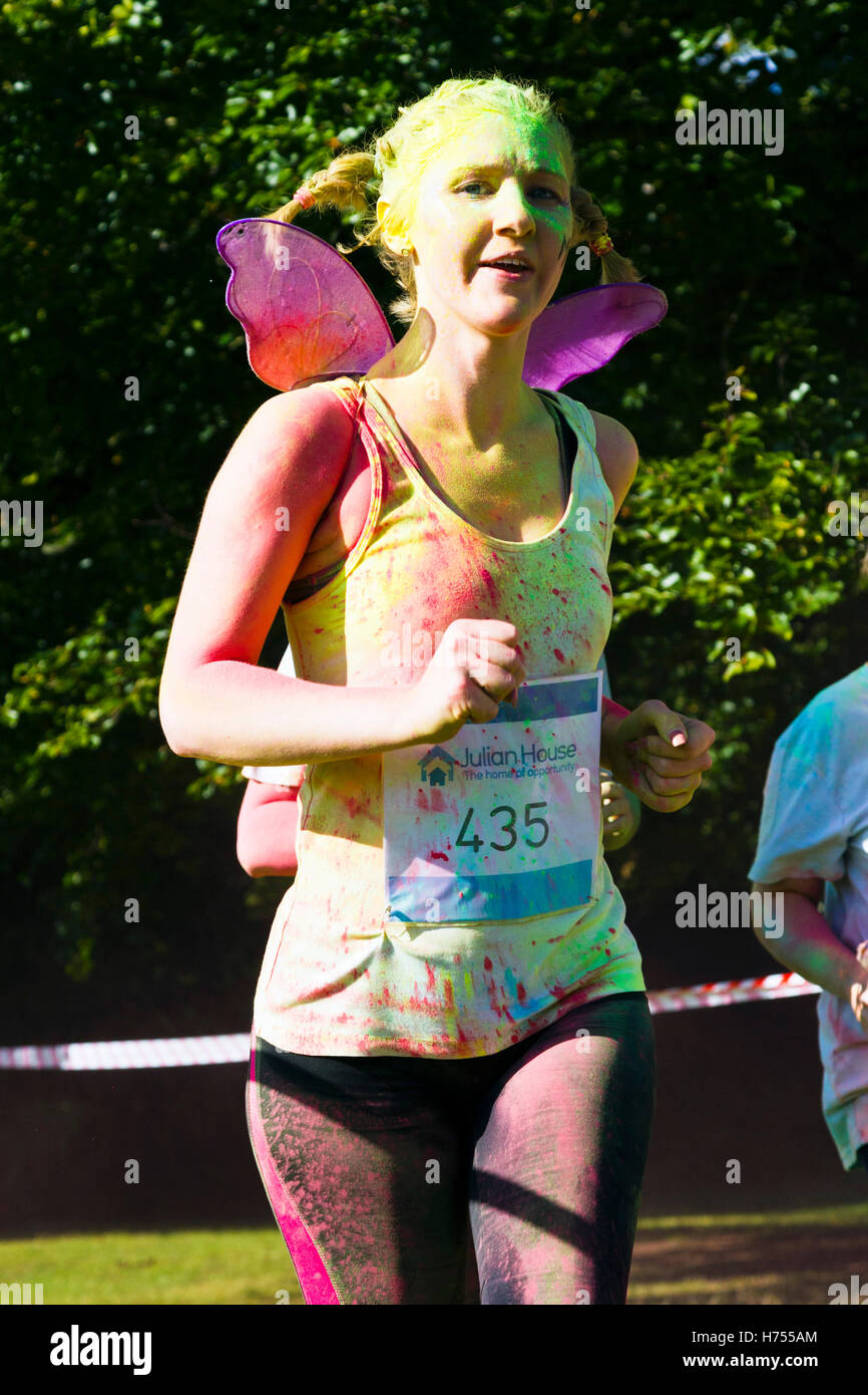 A runner in a charity (Julian House) Colour Fun Run held at Oldbury Court Estate, Bristol, October 2016 Stock Photo