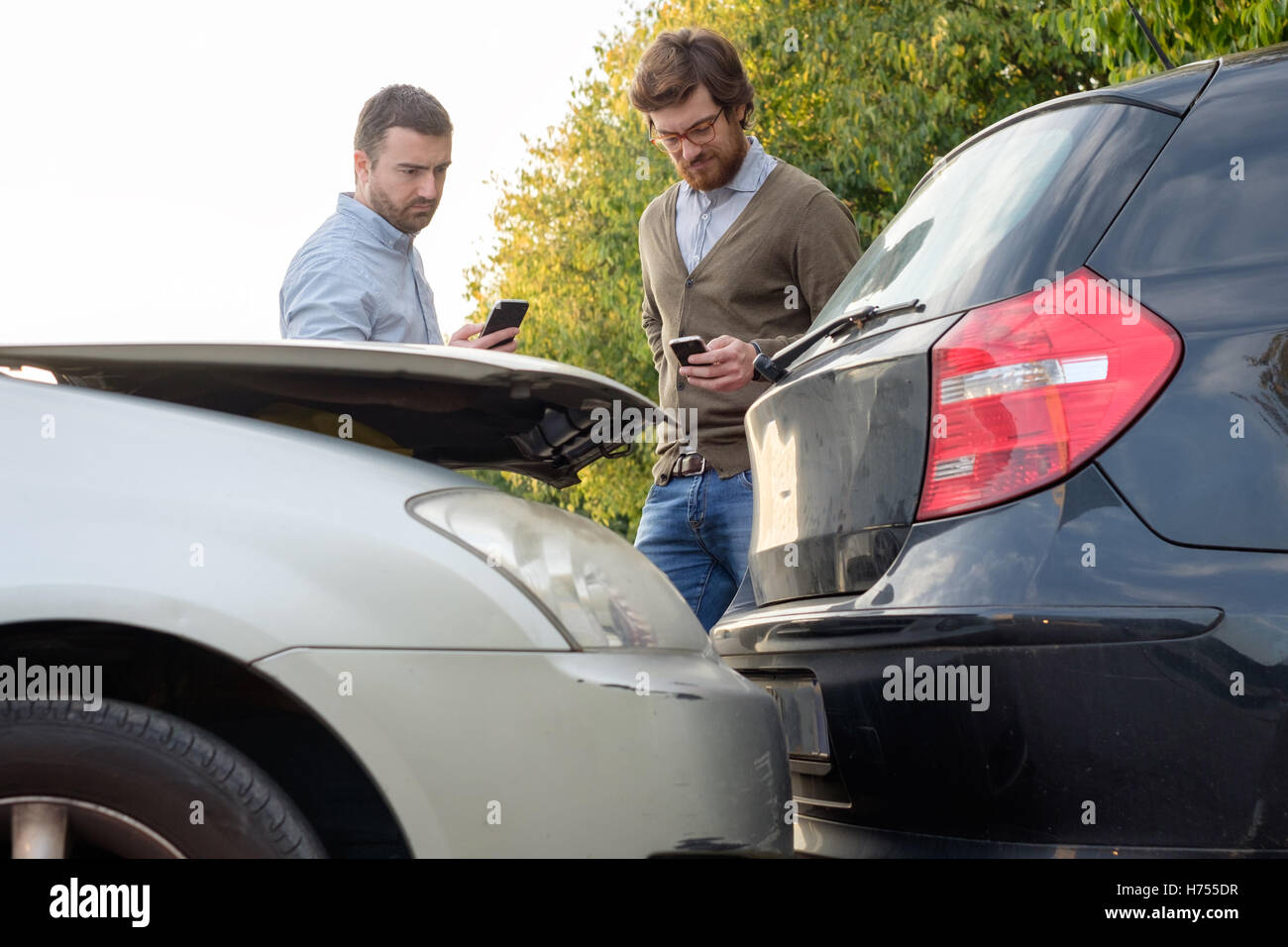 Men calling car mechanic insurance assistance after car accident Stock Photo