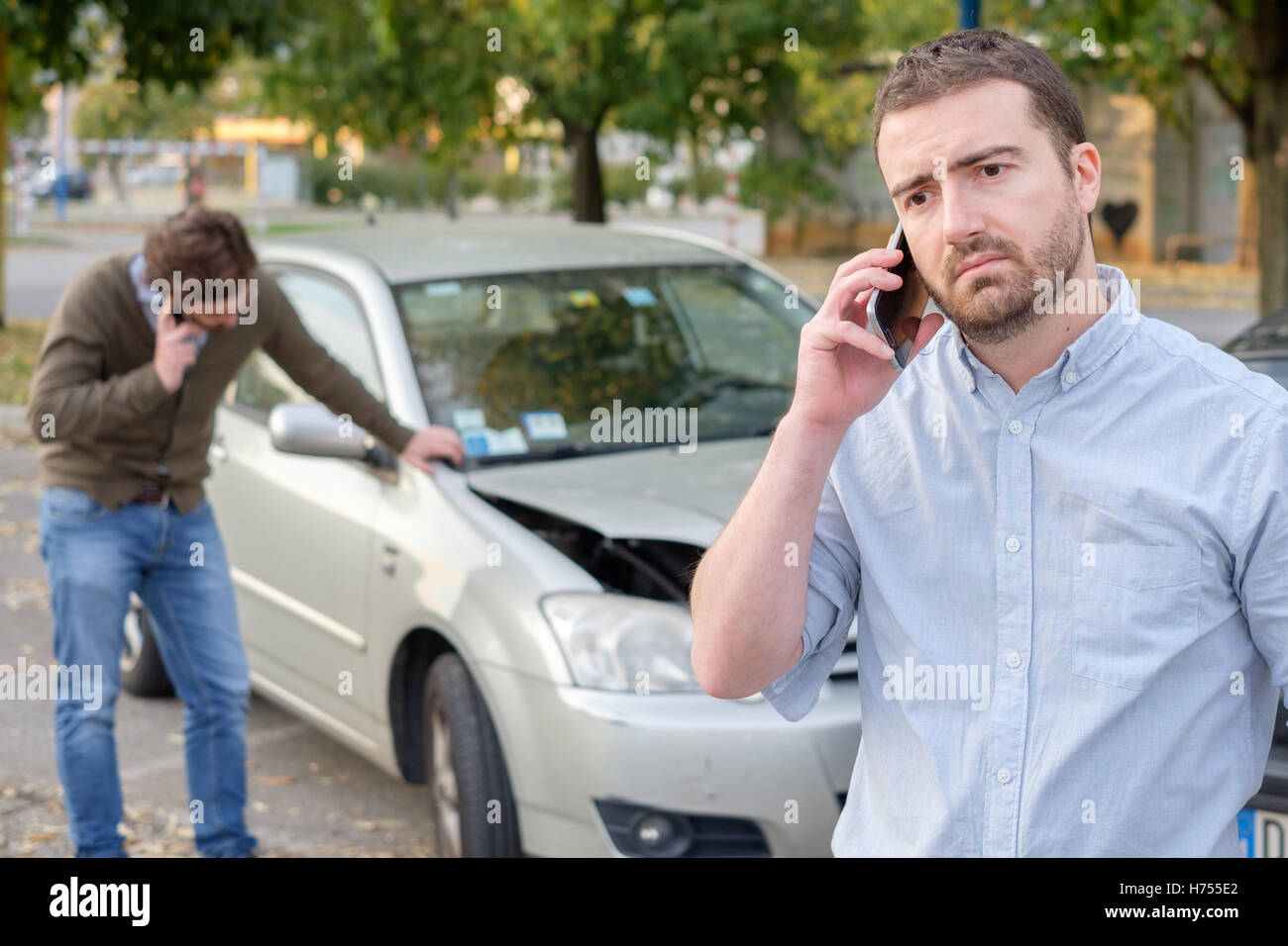 Man calling car mechanic insurance assistance after car accident Stock