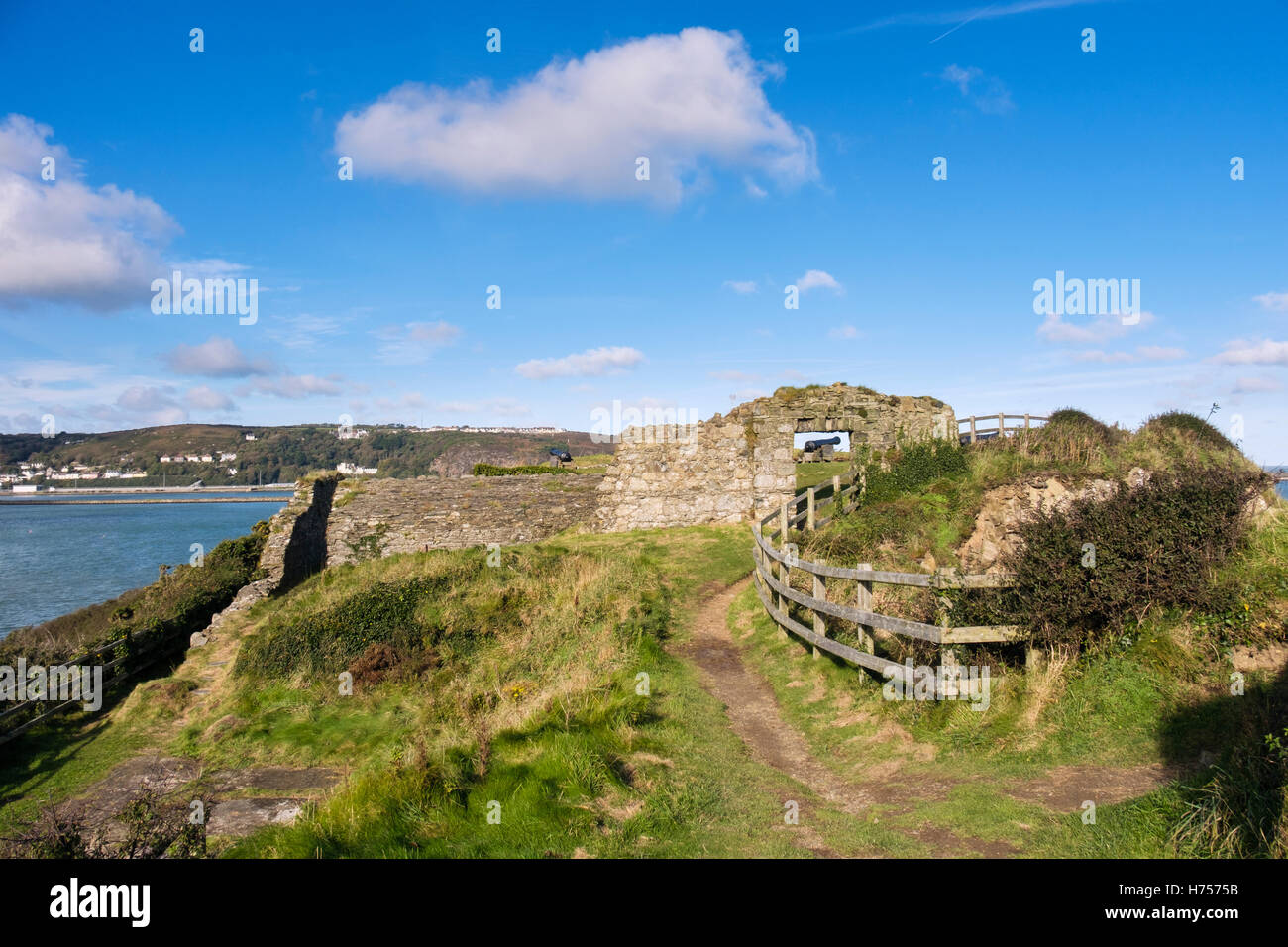 Wales Coast Path and old fort ruins 1781 on headland overlooking bay in National Park. Fishguard Pembrokeshire Wales UK Stock Photo