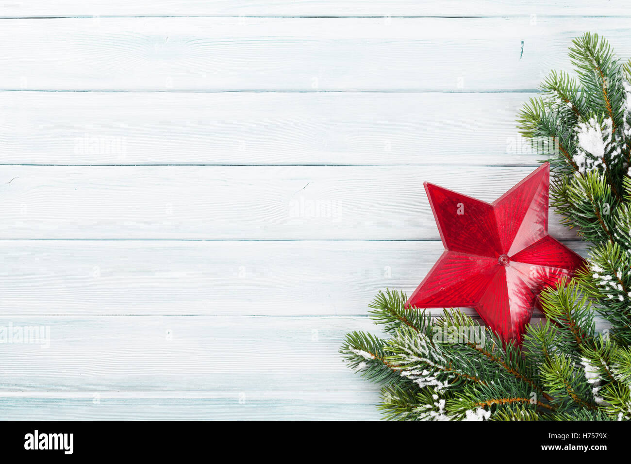 Christmas wooden background with snow fir tree and star decoration. Top ...