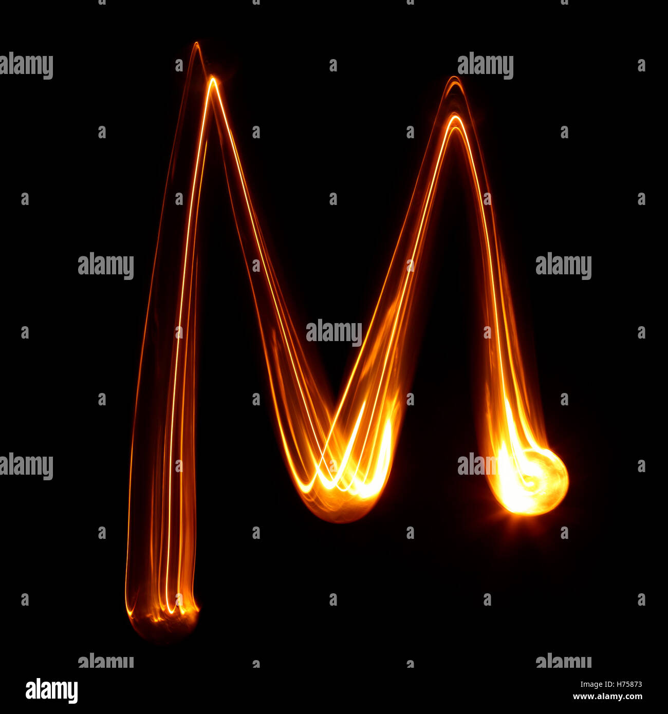 M - Pictured by light letters Stock Photo