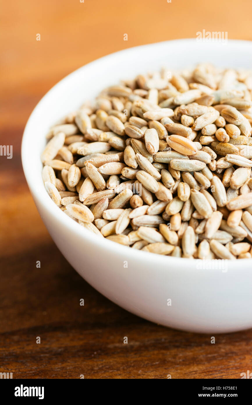 Rye grains in a small bowl. Stock Photo