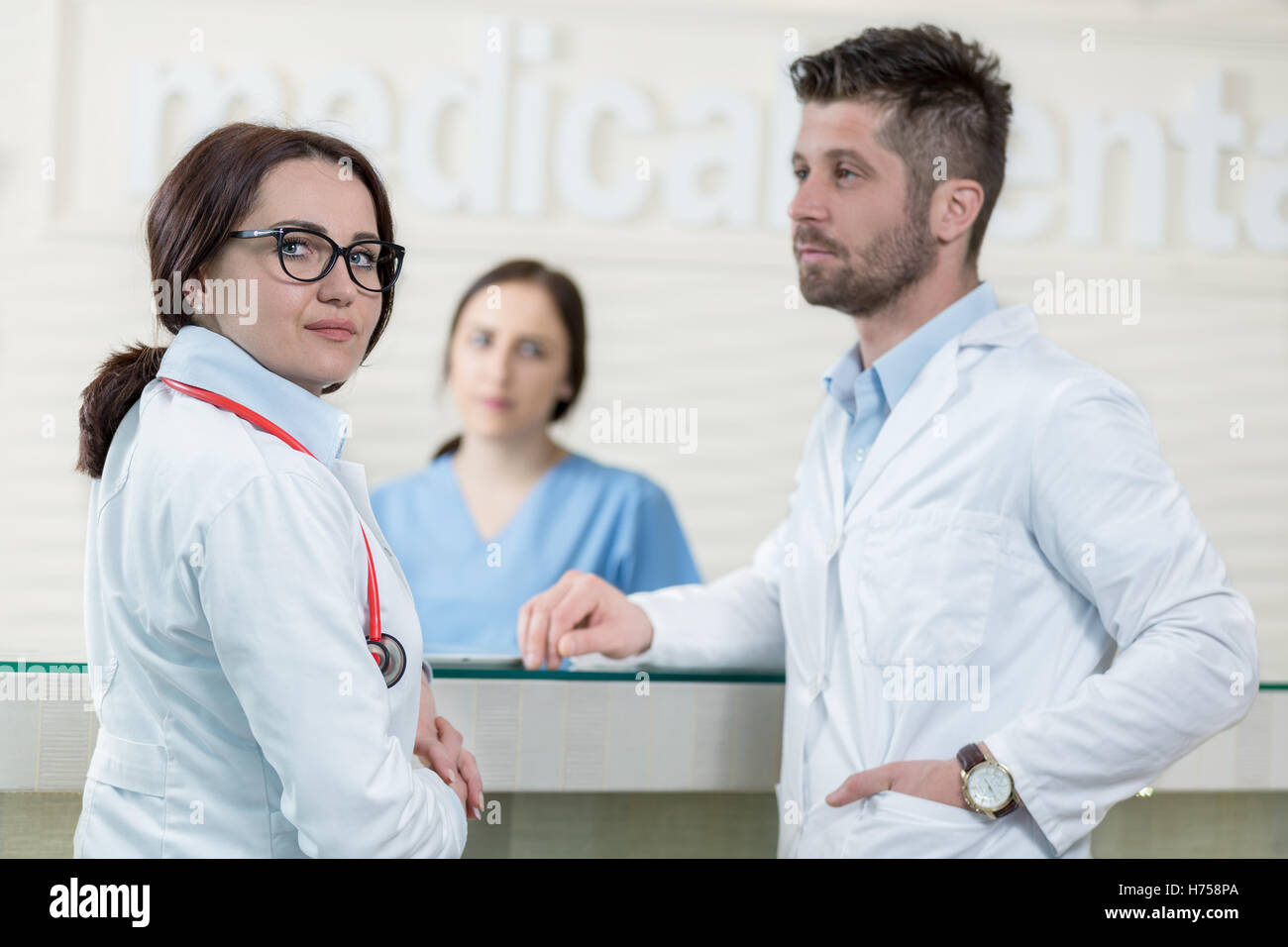 Medical Staff Having Discussion In Modern Hospital Corridor Stock Photo ...