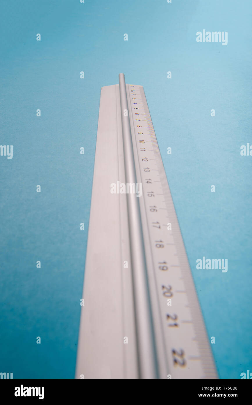 aluminum ruler on blue background. High resolution Stock Photo - Alamy