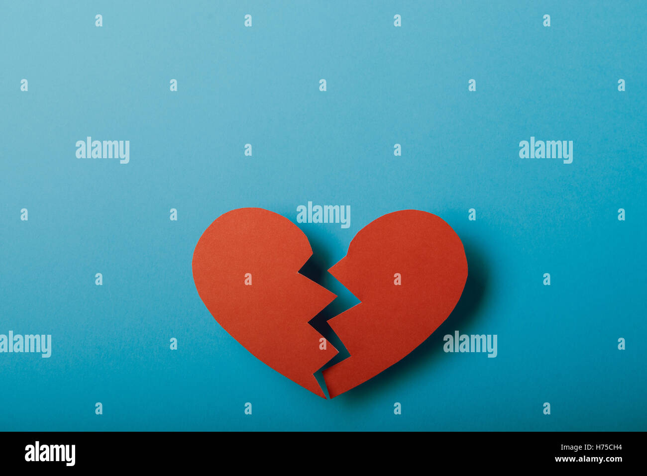 Red paper Valentines Day heart against a blue background Stock Photo ...