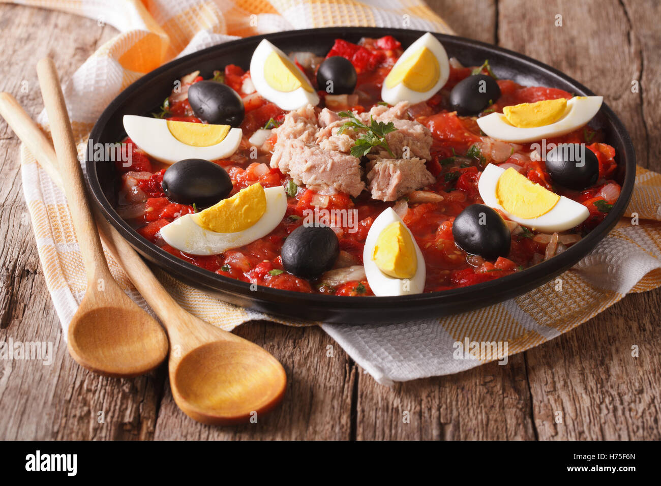 Traditional Tunisian salad with tuna, eggs, and vegetables on the table. horizontal Stock Photo