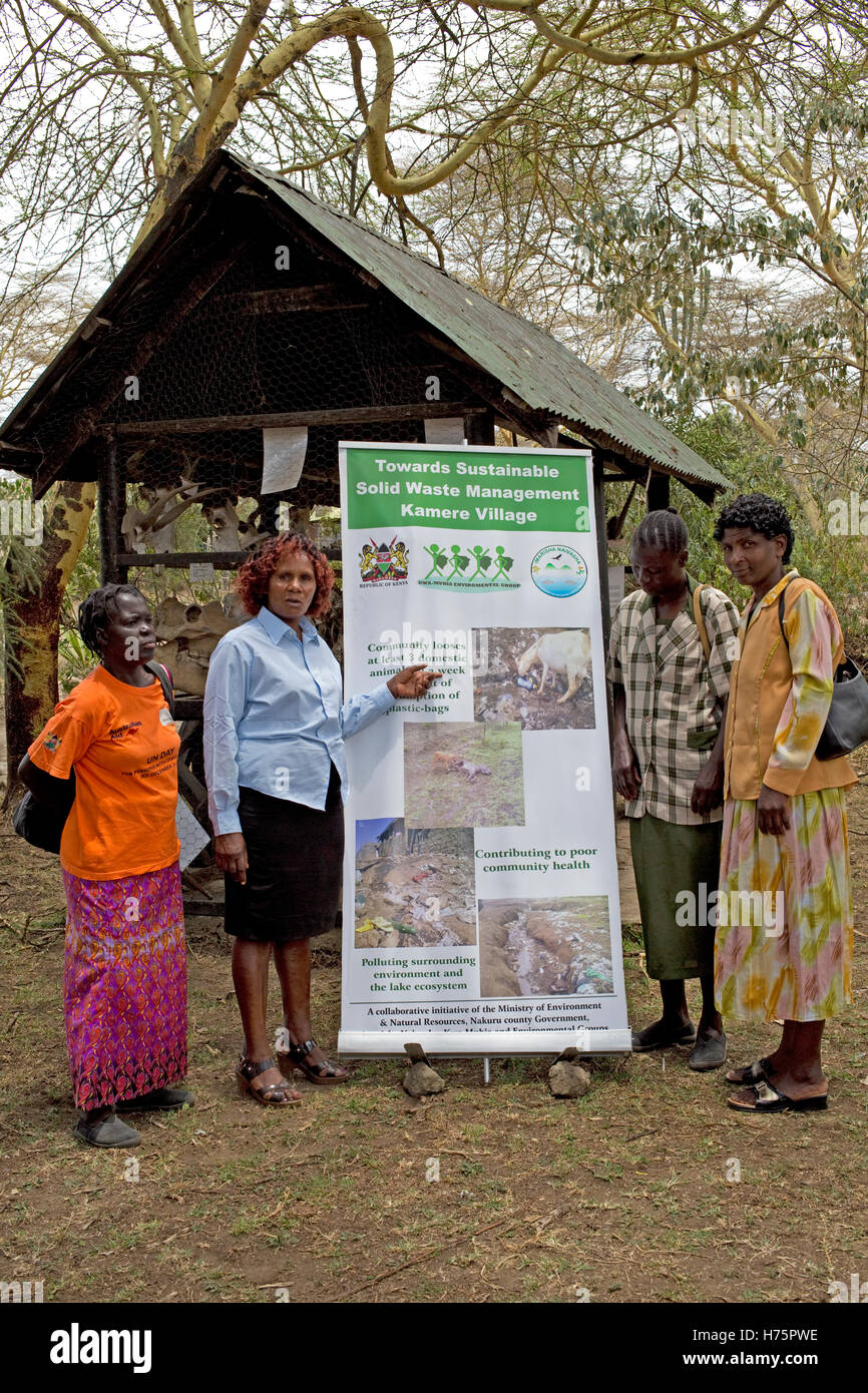 Four women with waste management poster Kamere Kenya Stock Photo