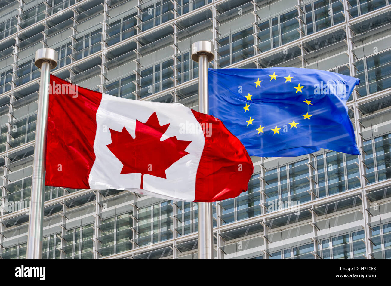 Canadian and European flags waving in the wind (montage) Stock Photo