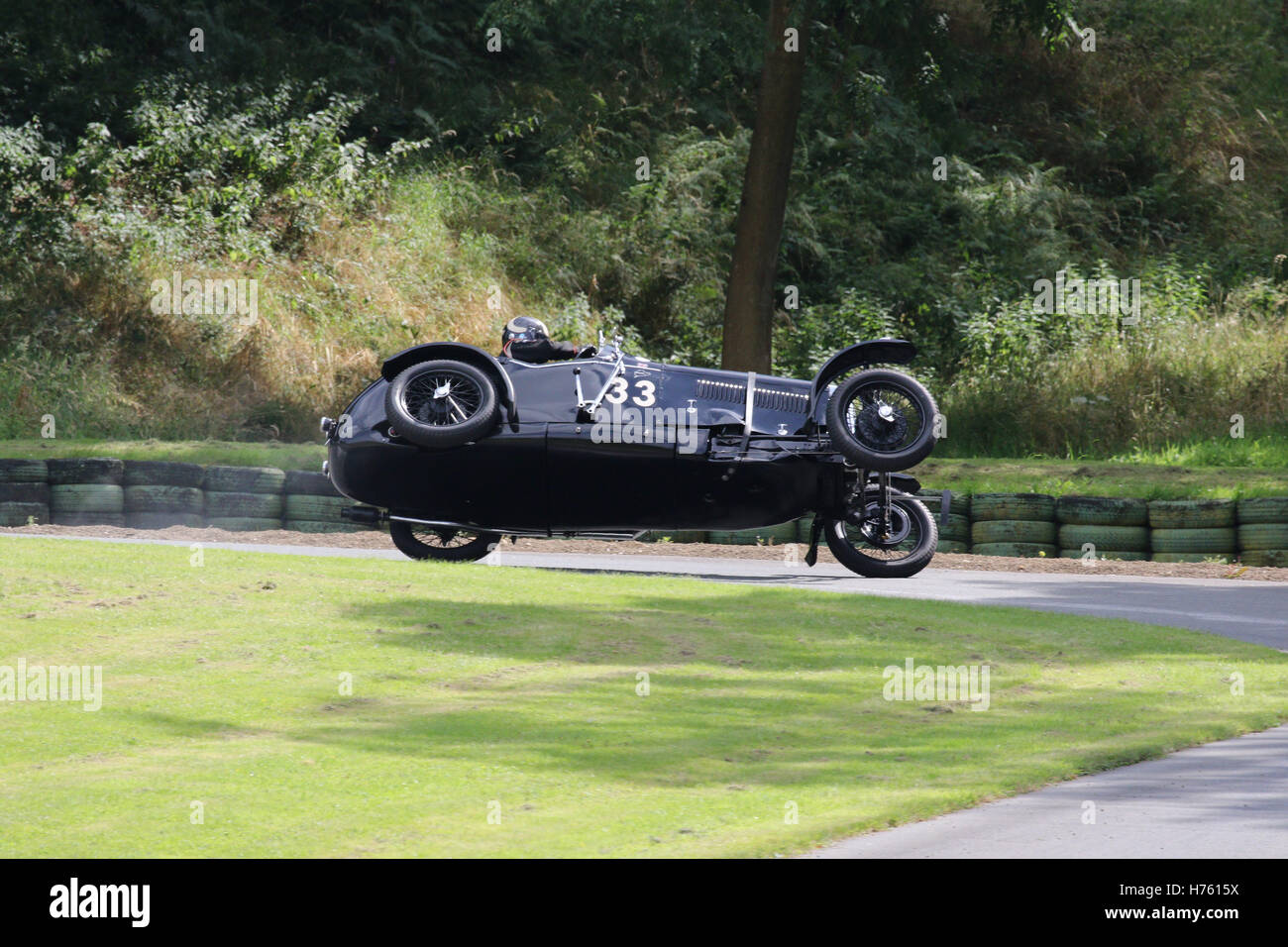 Frazer Nash car balancing on two wheels and nearly tipping over during hill climb event at Prescott Stock Photo