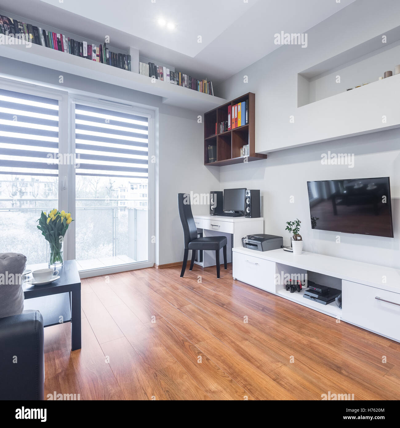 Spacious Tv Living Room With Balcony And White Furniture