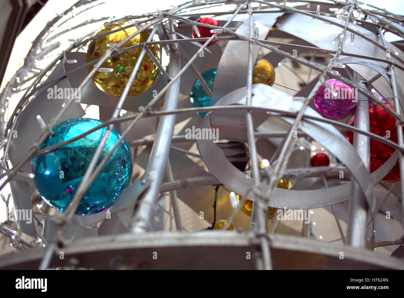 Christmas balls golden red blue purple steel cage Stock Photo
