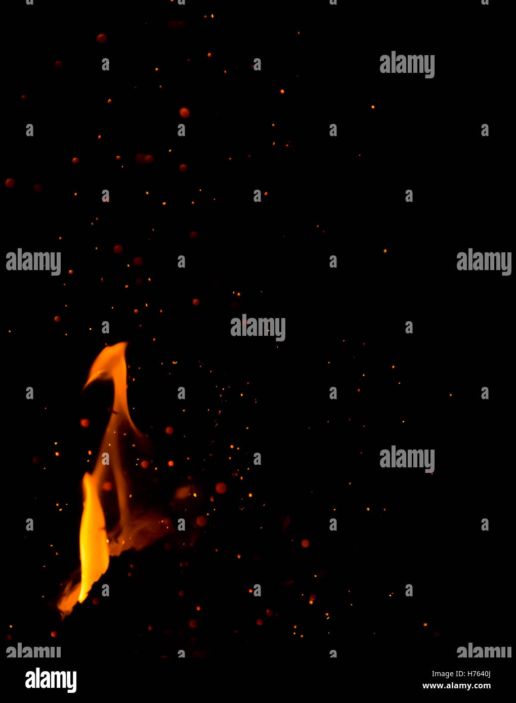 Flames and glowing sparks from bonfire, against dark background Stock ...