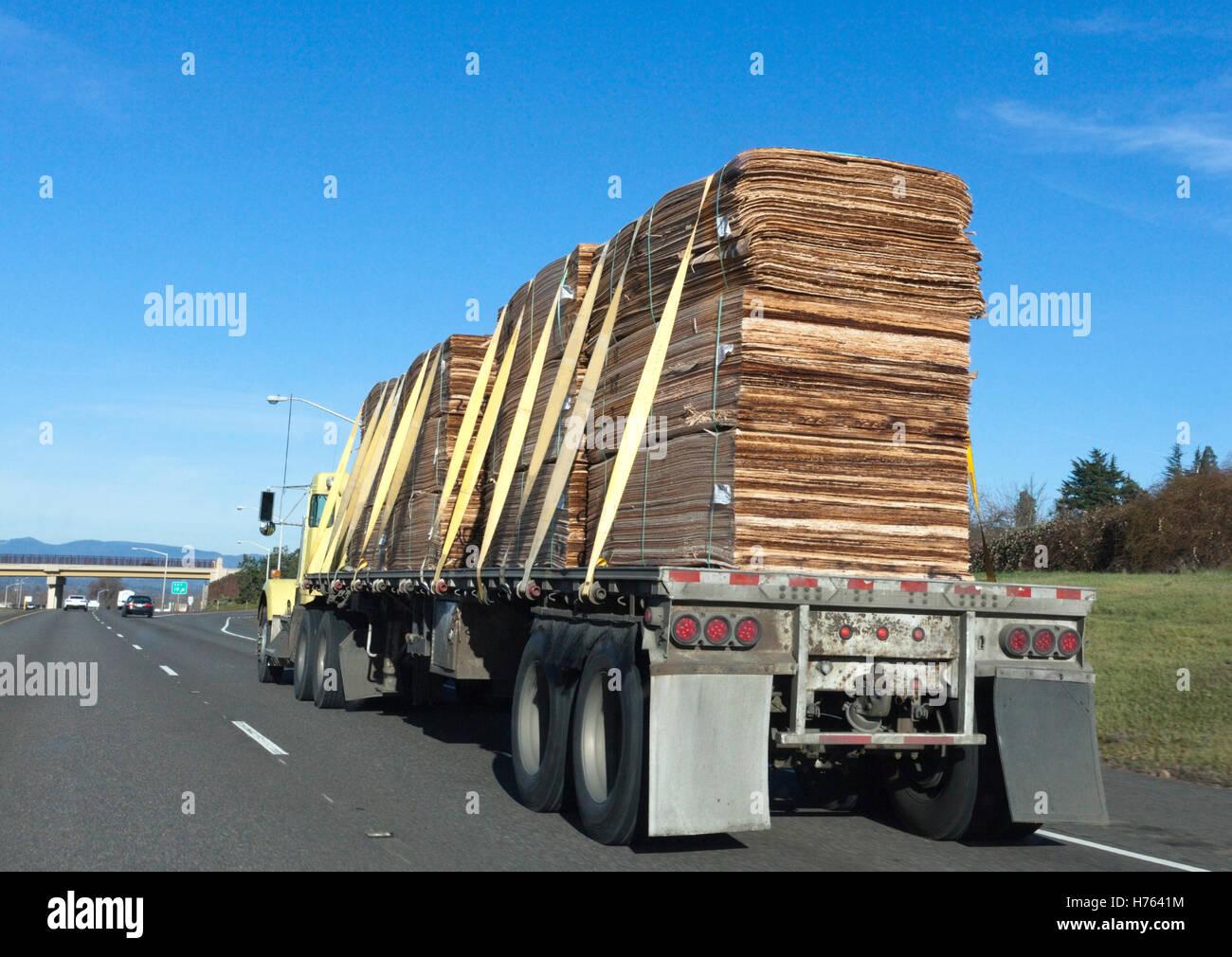 Flatbed trailer hauling lumber freight under blue sky Stock Photo Alamy