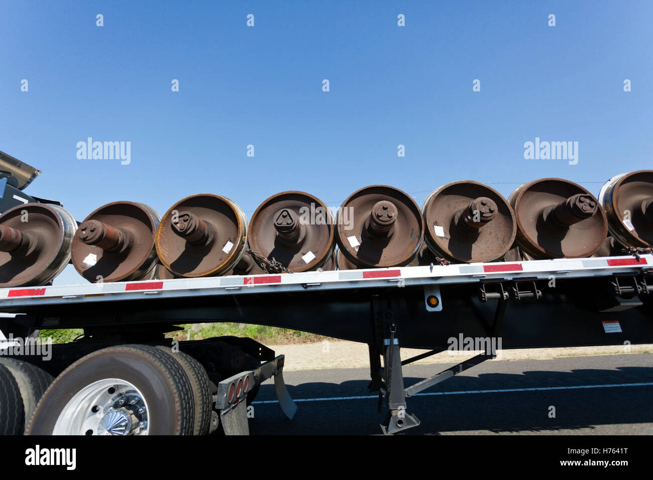Side view of railroad wheel freight on flatbed semi Stock Photo Alamy