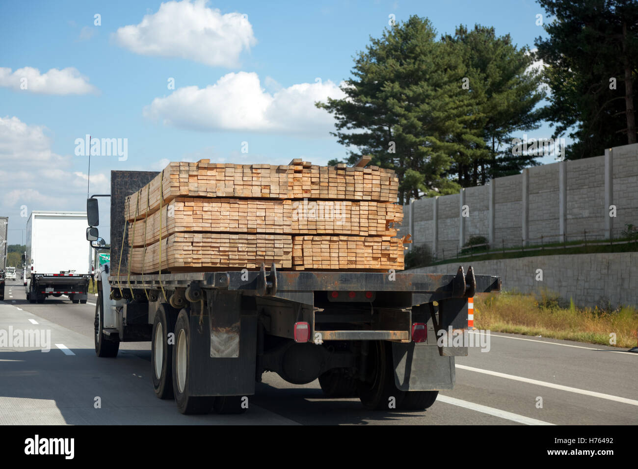 Truck on highway with lumber cargo Stock Photo