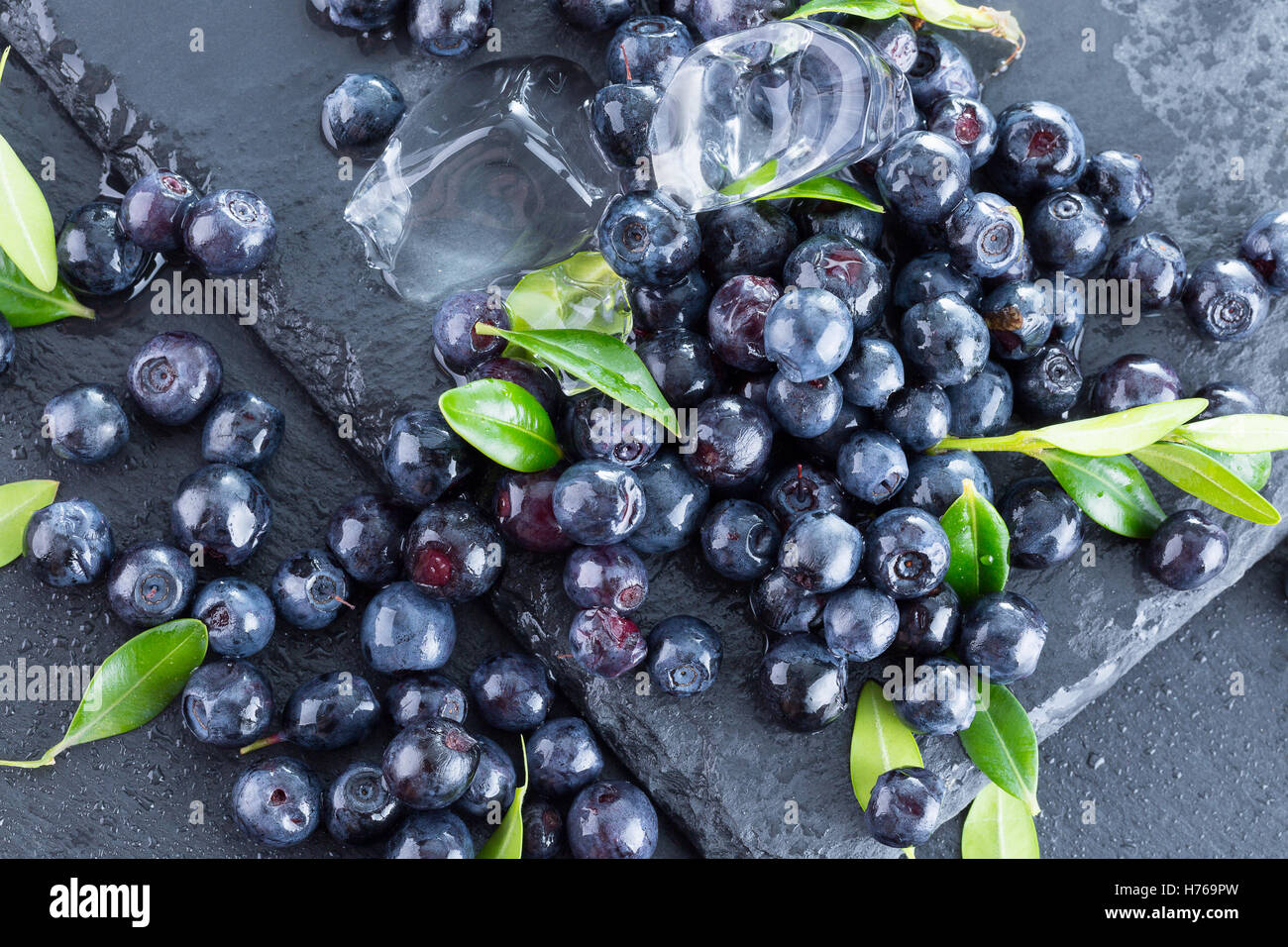 blueberries with ice cubes on slate plate. Stock Photo