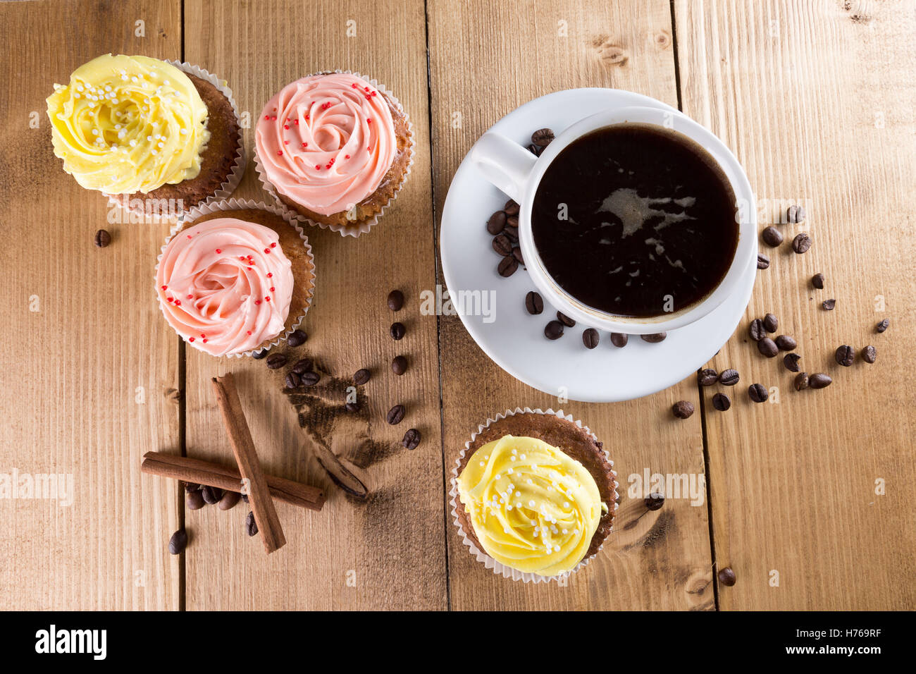 cupcakes with coffee on wooden background. Stock Photo