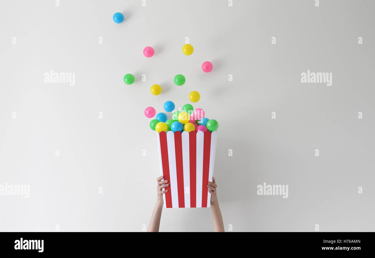 Hands holding conceptual tub of popcorn Stock Photo
