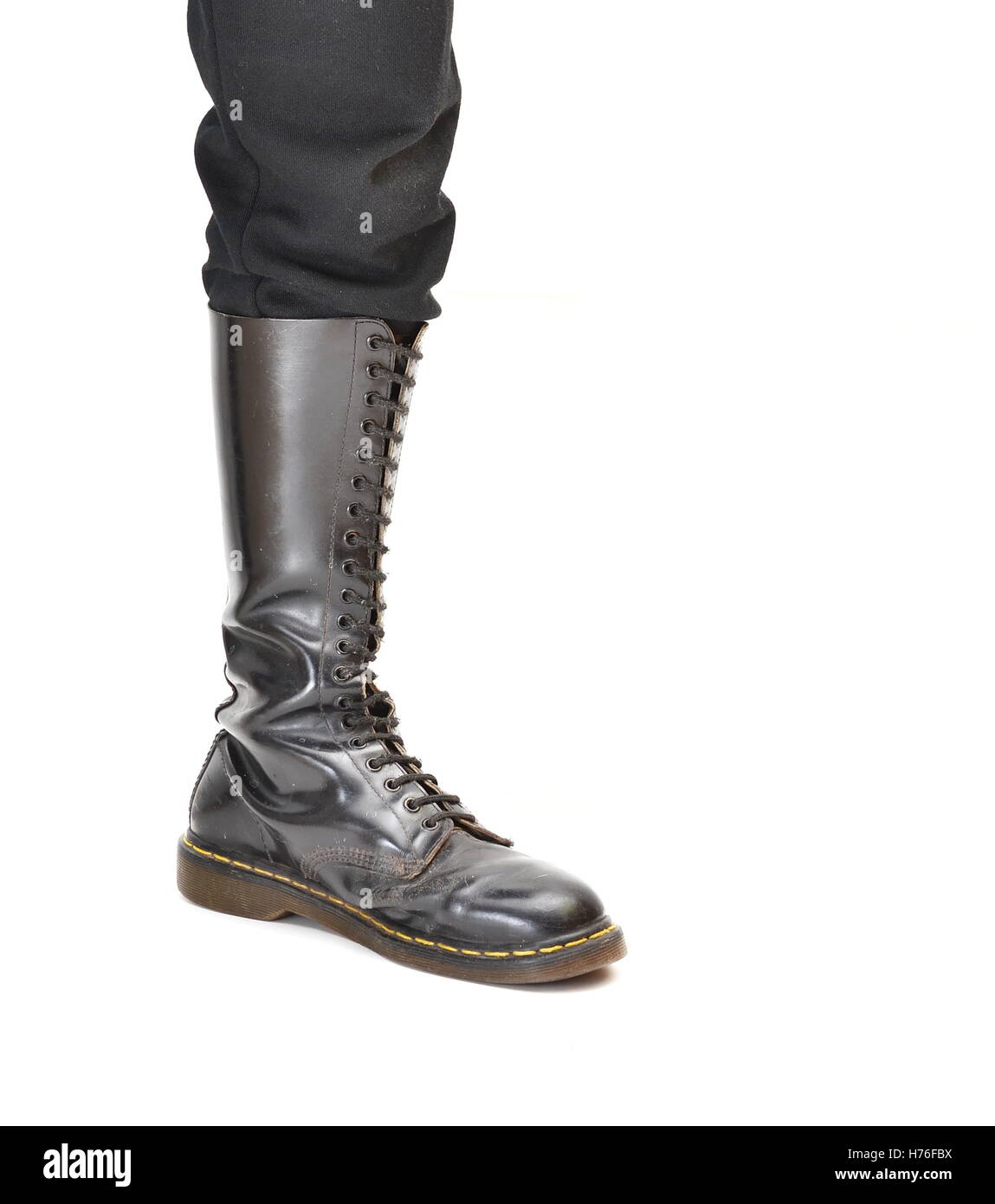 An old and rugged men's/unisex knee-high black 20-eyelet lace-up combat boot Stock Photo