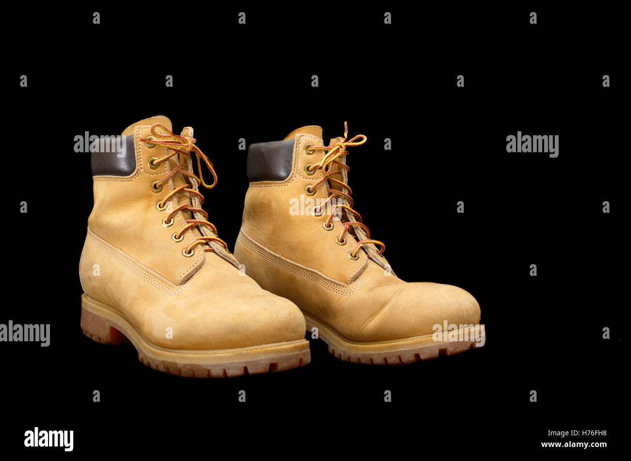 Authentic pair of 8 inch Yellow Work Boots isolated on black Stock Photo
