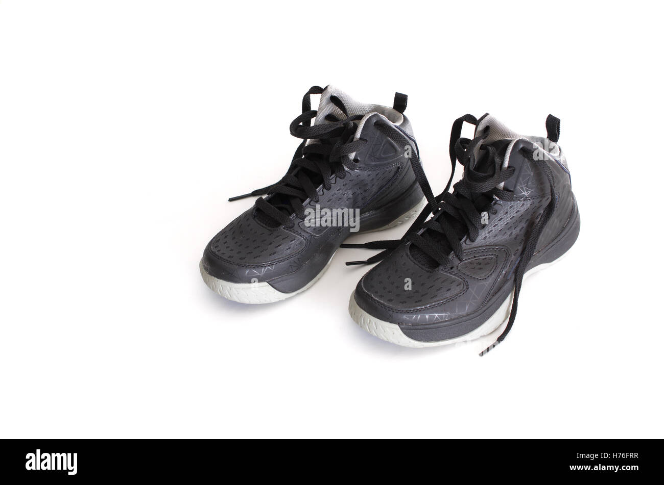 Children's modern high-top black leather and mesh basketball shoes,  sneakers isolated on white Stock Photo