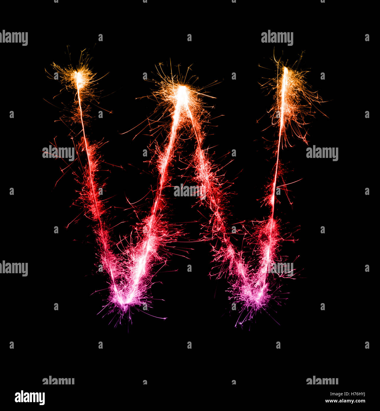 Sparkler firework light alphabet W at night background Stock Photo